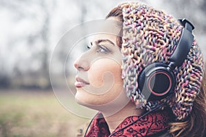 Beautiful brunette woman listening to music with headphones