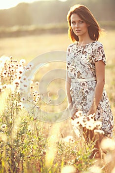 Beautiful brunette woman outdoors on a sunset