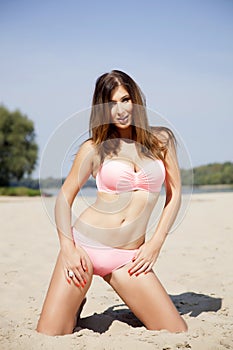 Beautiful brunette woman in pink bikini