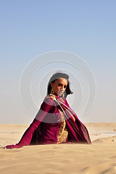 Beautiful brunette woman posing in arabic desert