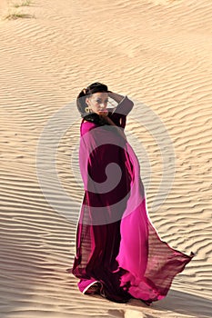 Beautiful brunette woman posing in arabic desert