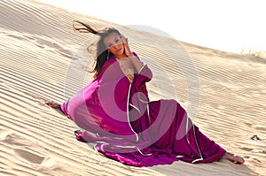 Beautiful brunette woman posing in arabic desert