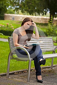 Beautiful brunette woman reading a book
