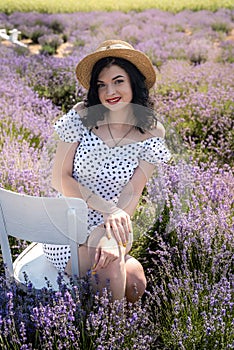 Beautiful brunette woman with red lipstick posing lavender field