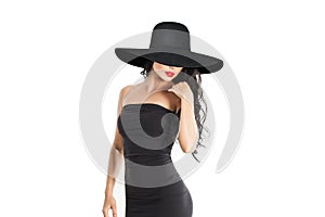 Beautiful brunette woman. Sexy fashion model with long brown hair and wide black broad brim hat