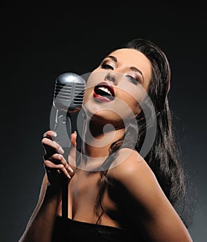 Beautiful brunette woman singing