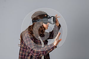 Beautiful brunette woman testing virtual reality helmet