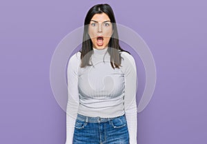 Beautiful brunette woman wearing casual clothes afraid and shocked with surprise and amazed expression, fear and excited face