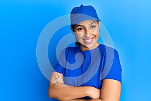 Beautiful brunette woman wearing delivery uniform happy face smiling with crossed arms looking at the camera