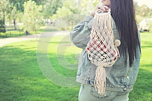 Beautiful brunette young woman with string bag