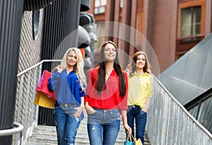 Beautiful brunettes and blond with shopping bags