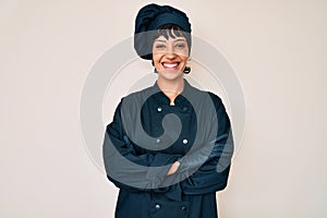 Beautiful brunettte woman wearing professional cook uniform happy face smiling with crossed arms looking at the camera