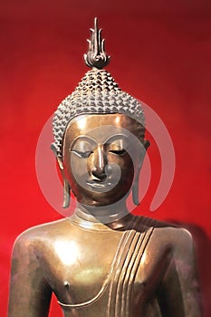 Beautiful buddha figurine, red background