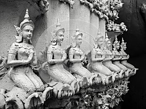 Beautiful buddhist sculpture hands clasped in prayer, detail of buddhist figures carved in Wat Sanpayangluang at Lamphun, Thailand