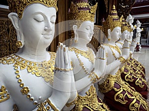 Beautiful buddhist sculpture hands clasped in prayer, detail of buddhist figures carved in Wat Sanpayangluang at Lamphun, Thailand