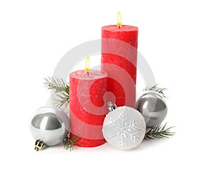 Beautiful burning candles with Christmas decor on white background