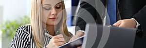 Beautiful business lady signing documents