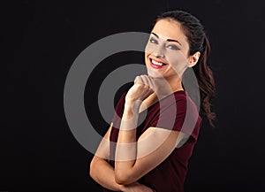 Beautiful business toothy enjoying laughing woman with long brown healthy curly hair style in dark red shirt clothing. Closeup