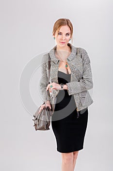 beautiful business woman blonde in black dress, jacket and purs