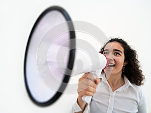 Beautiful business woman with curly hair holding a megaphone