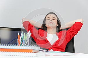 Beautiful business woman dreaming while working on computer at her office