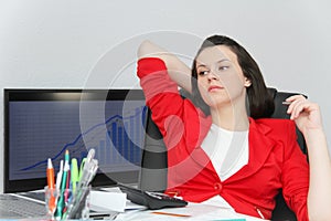 Beautiful business woman dreaming while working on computer at her office