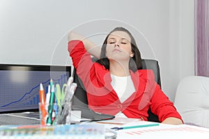 Beautiful business woman dreaming while working on computer at her office