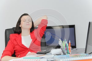 Beautiful business woman dreaming while working on computer at her office