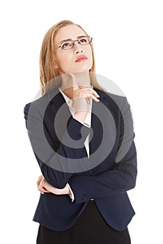 Beautiful business woman in eyeglasses with finger on her cheek.