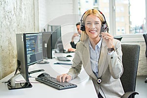 Beautiful business woman with headset working in call center