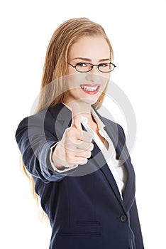 Beautiful business woman with her thumb up, showing oK.