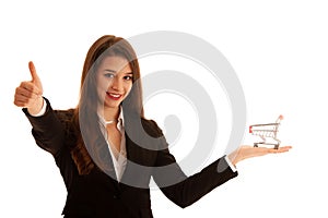 Beautiful business woman holds shopping cart isolated over white background