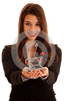 Beautiful business woman holds shopping cart isolated over white background