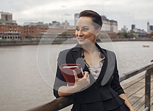 Beautiful business woman loking at the river