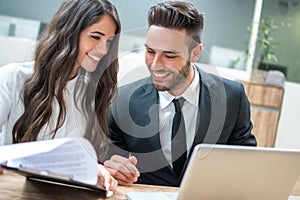 Beautiful business woman and man working together at office.