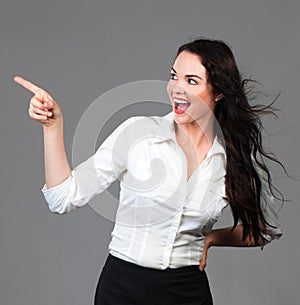 Beautiful business woman pointing at copyspace