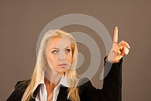 Beautiful business woman presing avirtual button on a transparent board