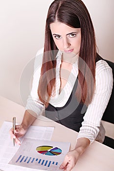 Beautiful business woman reading documents