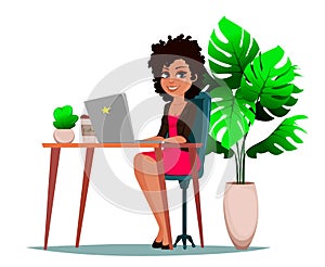 Beautiful business woman sitting at the table with laptop, plant and coffee.
