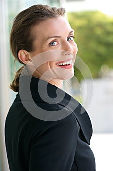 Beautiful business woman smiling outside