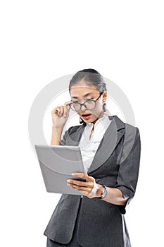 Beautiful business woman surprised looking the tablet while touching her glasses