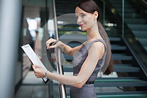 Beautiful business woman taking notes