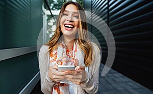 Beautiful business woman using mobile phone outdoors. People communication technology concept.