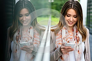 Beautiful business woman using mobile phone outdoors. People communication technology concept.