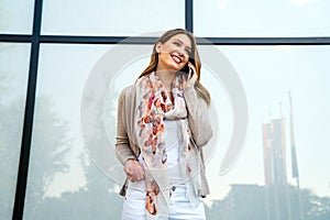 Beautiful business woman using mobile phone outdoors. People communication technology concept.