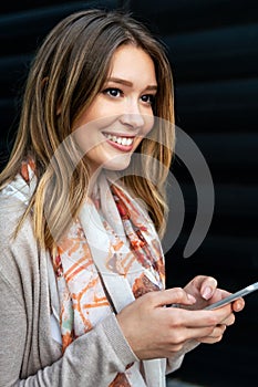 Beautiful business woman using mobile phone outdoors. People communication technology concept.