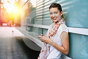 Beautiful business woman using mobile phone outdoors. People communication technology concept.