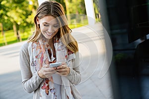 Beautiful business woman using mobile phone outdoors. People communication technology concept.