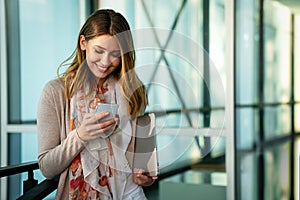 Beautiful business woman using mobile phone outdoors. People communication technology concept.