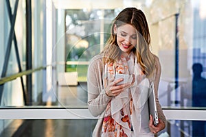 Beautiful business woman using mobile phone outdoors. People communication technology concept.